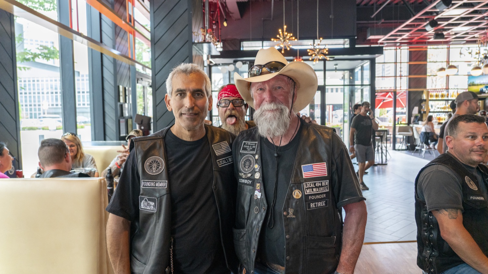 A founding member and a retired member of EWRC1 in their club vests at a gathering.