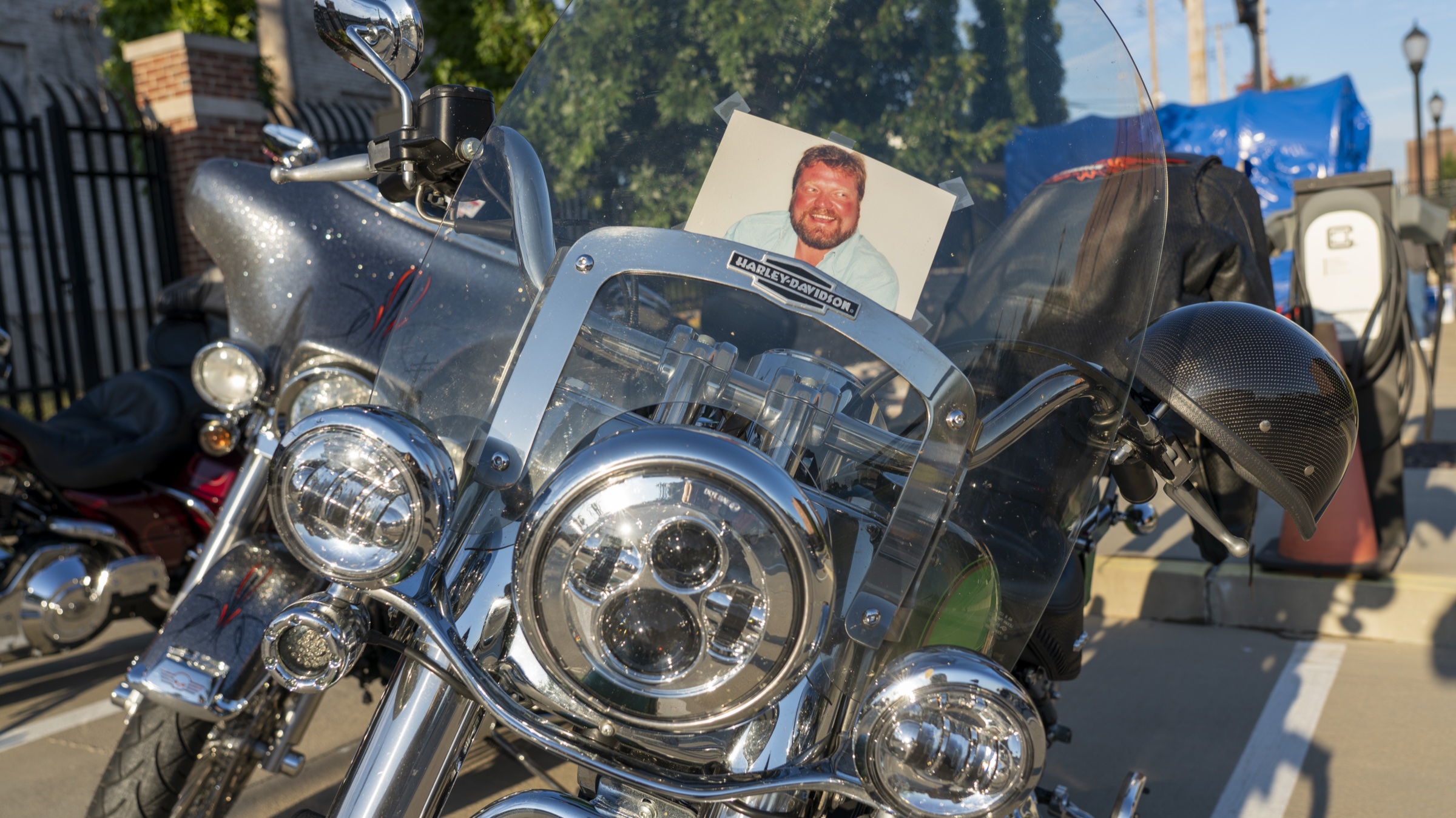 A club Harley with Greg Booth's portrait taped to the windshield at the Greg Booth Ride.