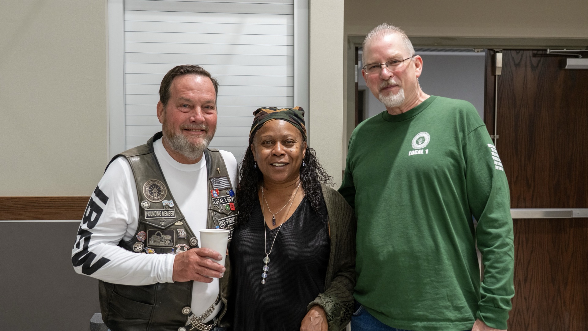 Patrick Bittick, EWRC1 Vice President (left), with his wife and Chuck DeMoulin at the Local 1 hall.